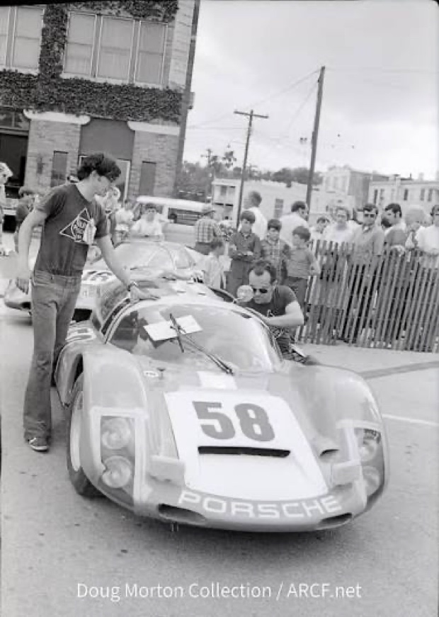 A vintage Porsche sports racer, number 58, at a street circuit