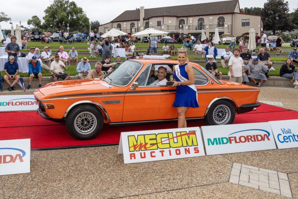 A bright orange coupe on the red carpet