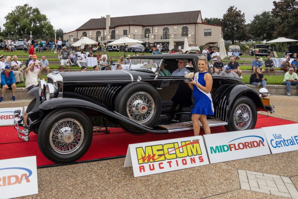A black prewar classic with whitewall tires on the red carpet